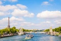 Cityscape of the river Seine in Paris, France, with a bateau-mouche, the pont Alexandre III and the Eiffel tower by a sunny day Royalty Free Stock Photo