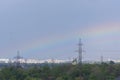 Cityscape with rainbow over the high voltage towers Royalty Free Stock Photo