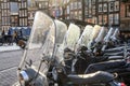 Cityscape on a rainy day - street view with scooter parking in the historic center of Amsterdam Royalty Free Stock Photo