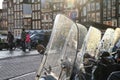 Cityscape on a rainy day - street view with scooter parking in the historic center of Amsterdam Royalty Free Stock Photo