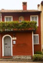 Cityscape of a facade and wood door and shutters in the town of Varenna, Italy