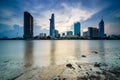 Cityscape in reflection of Ho Chi Minh city at beautiful sunset, viewed over Saigon river. Royalty Free Stock Photo