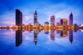 Cityscape in reflection of Ho Chi Minh city at beautiful twilight, viewed over Saigon river.