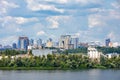 The beautiful cityscape of Kyiv with the Dnipro River, an industrial complex on the bank and new high-rise buildings on the Royalty Free Stock Photo