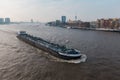 Cityscape of Rotterdam with a ship passing on the Maas