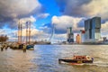 Cityscape of Rotterdam - view of the moored sailboat and the Erasmus Bridge with Tower blocks in the Kop van Zuid neighbourhood