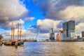 Cityscape of Rotterdam - view of the moored sailboat and the Erasmus Bridge with Tower blocks in the Kop van Zuid neighbourhood