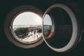 A cityscape through the round window