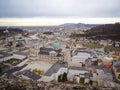 Cityscape of Salzburg city with cathedral and monastery with mountains in background