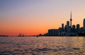 Cityscape - silhouettes of skyscrapers, calm lake old sail ship and yacht. Royalty Free Stock Photo