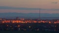 Cityscape skyline transitioning from day to night timelapse.