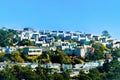 Cityscape with sprawling neighborhood and rows of decorative modern houses in late afternoon sun with blue sky Royalty Free Stock Photo