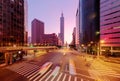 Cityscape of a street corner in Downtown Taipei City with traffic trails in morning twilight