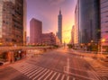 Cityscape of a street corner in Downtown Taipei City with traffic trails in morning twilight