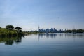 Cityscape Toronto - silhouettes of skyscrapers, calm lake, forest and yacht. Blue tone Royalty Free Stock Photo