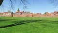 Cityscape of town Wittstock Dosse in Germany. People walking through small park at town wall.