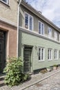 Traditional house with hollyock plant  on cobbled sidewalk , Helsingor, Denmark Royalty Free Stock Photo