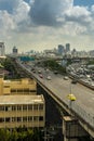 Cityscape and transportation with expressway and traffic in daytime from skyscraper of Bangkok.