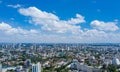 Cityscape with urban design, buildings, and cumulus clouds under a blue sky Royalty Free Stock Photo