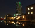 Cityscape view of canal wharfe in leeds at night with illuminated buildings and bridge reflected in the river with bridgewater Royalty Free Stock Photo