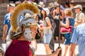 Cityscape - view of a man dressed in a red tunic and armor of a Roman legionnaire against the backdrop of tourists, Diocletian`s P