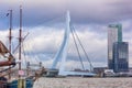 Cityscape - view of the moored sailboat on a background of skyscrapers district Feijenoord city of Rotterdam and the Erasmus Bridg Royalty Free Stock Photo