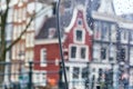 Cityscape - view on the old houses of Amsterdam in the rain through motorcycle windshield Royalty Free Stock Photo