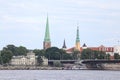 Cityscape view of Old Riga house and church towers in background and yach pier in foreground Royalty Free Stock Photo