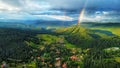 Cityscape view of rainbow cloudy sky over heaven green forest and rural houses