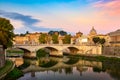 Cityscape view of Rome at colorful sunset with Ponte Sant Angelo and St Peter Cathedral in Vatican Royalty Free Stock Photo