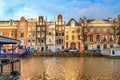 Cityscape - view of the water canal with houseboats in the historic center of Amsterdam, the Netherlands Royalty Free Stock Photo