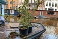 Cityscape on a winter day - view of houseboats on the water channel in the historic center of Amsterdam