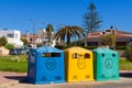 A row of colorful dustbins for waste segregation