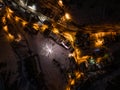 Civetta city night drone view. Fireworks in new year in dolomites . Aerial view of the city at night. Long exposure photo.