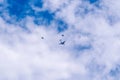 Civil aircraft escorted by two fighters on a blue sky with clouds. Selective focus, aviation concept. Royalty Free Stock Photo