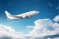 Civil aircraft flying into deep blue skies with some clouds Royalty Free Stock Photo