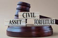 CIVIL ASSET FORFEITURE - words on wooden blocks against the background of a judge\'s gavel with a stand