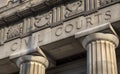 Looking up at Civil Courts building with stone Greek flutted columns and ornate design