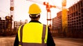 Civil engineer or architect with hardhat overlooking construction site works Royalty Free Stock Photo