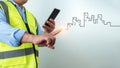 Civil engineer architect Using a smartphone to communicate and give orders to the construction team, Engineer building concept, Royalty Free Stock Photo
