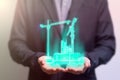 Civil engineer holding a hologram crane building construction