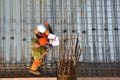 Civil engineer inspecting the work progress of a worker in a con