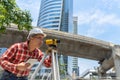 Civil engineer land survey with tacheometer or theodolite equipment. Worker Checking construction site on the road. Surveyor