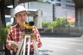 Civil engineer land survey with tacheometer or theodolite equipment. Worker Checking construction site on the road. Surveyor