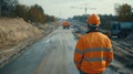 Civil engineer overseeing road construction and supervising major expressway project progress Royalty Free Stock Photo