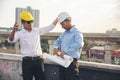 Civil engineer teams meeting working together wear worker helmets hardhat on construction site in modern city. Foreman industry Royalty Free Stock Photo