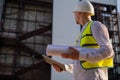 Civil engineer using a tablet, planning a project, builds a modern structure, reading a plan. Architect or engineer working on a Royalty Free Stock Photo