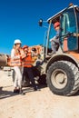 Civil engineer and worker discussion on road construction site Royalty Free Stock Photo