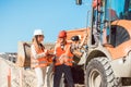 Civil engineer and worker discussion on road construction site Royalty Free Stock Photo