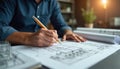 Civil engineer working on blueprint project at construction site. Man draws architectural design with pencil at workstation. Royalty Free Stock Photo